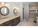 Modern bathroom featuring dual sinks, granite countertops, and a glass-enclosed shower at 2803 Wild Orchid Way, Columbus, IN 47201