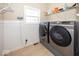 Efficient laundry room featuring front-loading washer and dryer, and storage shelves at 2803 Wild Orchid Way, Columbus, IN 47201