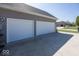 A spacious three-car garage with white doors and ample parking provides convenience and storage at 2803 Wild Orchid Way, Columbus, IN 47201