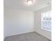 A well-lit bedroom featuring a large window, neutral walls, and plush carpeting creating a welcoming space at 288 Commodore Dr, Pittsboro, IN 46167