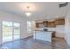 Modern kitchen featuring stainless steel appliances, a center island and large sliding glass door at 288 Commodore Dr, Pittsboro, IN 46167