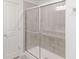 Tiled shower with glass doors at 288 Commodore Dr, Pittsboro, IN 46167