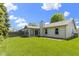 Spacious backyard featuring a well-maintained lawn, sunroom, and patio area at 3114 Village Park N Dr, Carmel, IN 46033