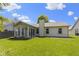 Backyard featuring a sunroom, lush lawn, and inviting atmosphere, perfect for relaxation at 3114 Village Park N Dr, Carmel, IN 46033