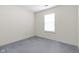 Simple bedroom with soft carpet and a large window for bright natural light at 3114 Village Park N Dr, Carmel, IN 46033