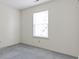 Bright bedroom featuring neutral walls, plush carpeting, and a window offering natural light at 3114 Village Park N Dr, Carmel, IN 46033