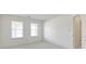Well-lit bedroom with two large windows, natural light, and a view to the hallway and bathroom at 3114 Village Park N Dr, Carmel, IN 46033