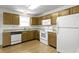 Functional kitchen featuring wooden cabinets, white appliances, and ample counter space for meal preparation at 3114 Village Park N Dr, Carmel, IN 46033