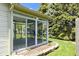 Enclosed sunroom with large windows that offer views of the well-manicured lawn at 3114 Village Park N Dr, Carmel, IN 46033