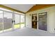 Relaxing sunroom featuring sliding doors to access outdoors and a glimpse into the kitchen at 3114 Village Park N Dr, Carmel, IN 46033