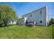 Large backyard featuring a hot tub, patio, outdoor grill, lounge seating, and a fenced yard at 3286 Hemlock St, Whiteland, IN 46184