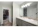 Bathroom with double sinks, decorative backsplash, and a view into the walk-in closet at 3286 Hemlock St, Whiteland, IN 46184