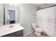 Well-lit bathroom features a modern vanity, toilet, and shower with decorative curtains at 3286 Hemlock St, Whiteland, IN 46184
