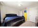 Cozy bedroom boasts a wooden bed frame, neutral carpet, and convenient access to closet and en-suite bathroom at 3286 Hemlock St, Whiteland, IN 46184