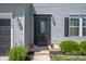 Charming home entrance with a decorative door, outdoor lighting, and well-maintained landscaping at 3286 Hemlock St, Whiteland, IN 46184