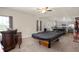 Large game room with a pool table, bar area, and adjacent kitchen for entertaining at 3286 Hemlock St, Whiteland, IN 46184