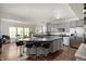 Modern kitchen featuring a large island with bar stools, stainless steel appliances, and hardwood floors at 3286 Hemlock St, Whiteland, IN 46184