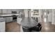 Well-lit kitchen with stainless steel appliances, gray cabinets, and large island with chairs at 3286 Hemlock St, Whiteland, IN 46184