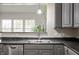 Close-up of the kitchen sink with stainless steel appliances and a view of the outdoors at 3286 Hemlock St, Whiteland, IN 46184
