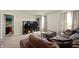 Living room with a large sectional couch, carpeted flooring, natural light, and a TV at 3286 Hemlock St, Whiteland, IN 46184