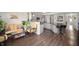 Living room with wicker furniture, plants, and an open floor plan leading to the kitchen at 3286 Hemlock St, Whiteland, IN 46184