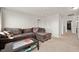 Living room with a large sectional couch, carpeted flooring, and open doorway at 3286 Hemlock St, Whiteland, IN 46184