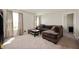 Comfortable living room with a large sectional couch, carpeted flooring, and natural light at 3286 Hemlock St, Whiteland, IN 46184