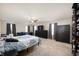 Bright main bedroom with large windows, ceiling fan, carpeted floor, dresser, and wardrobe at 3286 Hemlock St, Whiteland, IN 46184