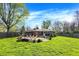 Expansive backyard with lush lawn, mature trees, and patio area, perfect for outdoor enjoyment at 360 Hope Ct, Greenwood, IN 46142