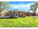 Spacious backyard featuring a well-maintained lawn, brick home, and a small storage shed at 360 Hope Ct, Greenwood, IN 46142