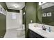Elegant bathroom featuring dark green walls, a shower-tub, and updated fixtures at 360 Hope Ct, Greenwood, IN 46142