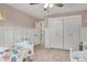 Charming bedroom with pink walls, closet, and light-colored wood flooring at 360 Hope Ct, Greenwood, IN 46142