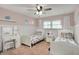 Charming bedroom with two beds, white furniture, and a ceiling fan, perfect for a room at 360 Hope Ct, Greenwood, IN 46142