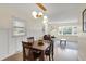 Cozy dining area with hardwood floors, modern lighting, and view of the backyard at 360 Hope Ct, Greenwood, IN 46142