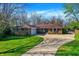 Charming brick home with a well-manicured lawn and a long driveway on a sunny day at 360 Hope Ct, Greenwood, IN 46142