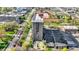 A stunning aerial view shows the high rise condo and the surrounding neighborhood, tennis courts, trees, and city at 4000 N Meridian St # 9E, Indianapolis, IN 46208