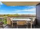 Inviting balcony with glass-topped table and chairs, perfect for enjoying the serene green space views at 4000 N Meridian St # 9E, Indianapolis, IN 46208