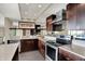 Modern kitchen with stainless steel appliances, dark cabinets, and ample counter space at 4000 N Meridian St # 9E, Indianapolis, IN 46208
