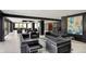 Modern living room area with black leather seating, artwork, and neutral tile flooring at 4000 N Meridian St # 9E, Indianapolis, IN 46208