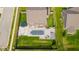 Aerial view of a fenced backyard complete with in-ground pool, patio and basketball court, perfect for outdoor living at 403 N Crystal Dr, Fortville, IN 46040