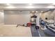 Spacious basement featuring workout equipment for a home gym, including a treadmill and weight machines at 403 N Crystal Dr, Fortville, IN 46040