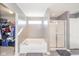 Bathroom features a walk-in shower with glass doors, a bathtub, and a spacious walk-in closet at 403 N Crystal Dr, Fortville, IN 46040