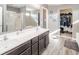 Bathroom features a double sink vanity, large mirror, and a walk-in closet with plenty of storage at 403 N Crystal Dr, Fortville, IN 46040
