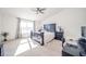 Bright bedroom features a ceiling fan, large window, and a dark wood bedroom suite at 403 N Crystal Dr, Fortville, IN 46040
