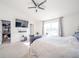 Bright bedroom features a flat screen TV and a large window with geometric patterned curtains at 403 N Crystal Dr, Fortville, IN 46040