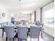 This dining room has neutral walls, modern chandelier, and a view into the living space at 403 N Crystal Dr, Fortville, IN 46040