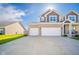 Exterior view of a two-story house with a three-car garage and a large driveway under a sunny sky at 403 N Crystal Dr, Fortville, IN 46040