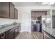 Modern kitchen featuring dark wood cabinets, granite countertops and stainless steel refrigerator at 403 N Crystal Dr, Fortville, IN 46040