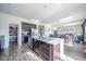An open-concept kitchen features an island and is connected to a dining and living area at 403 N Crystal Dr, Fortville, IN 46040