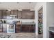 This kitchen features stainless steel appliances, granite countertops, and dark wood cabinetry at 403 N Crystal Dr, Fortville, IN 46040